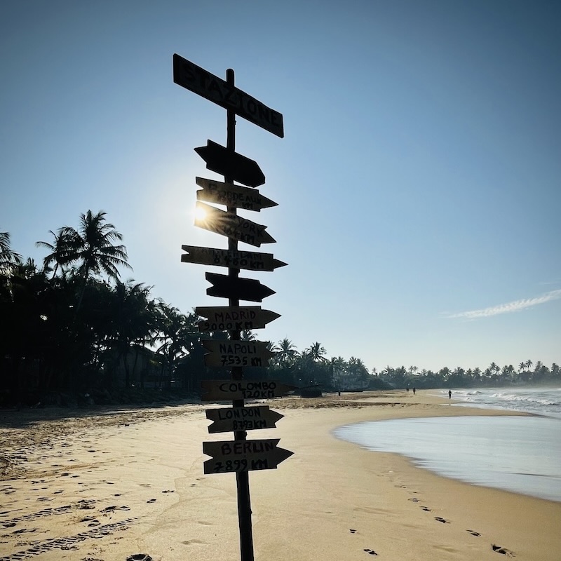 Sign with sun in golden yellow sand beach of Narigama, Hikkaduwa surfing Beach